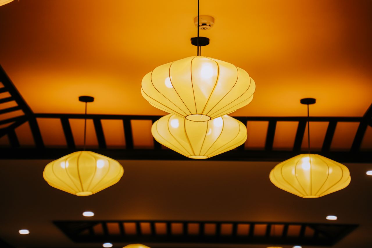 Services Elegant hanging lanterns with warm lighting create a cozy atmosphere indoors.