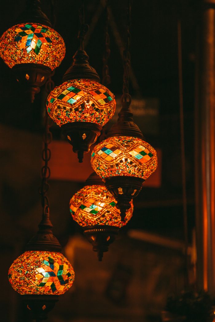 Services Vibrant mosaic ceiling lamps casting warm light in an intimate indoor setting.