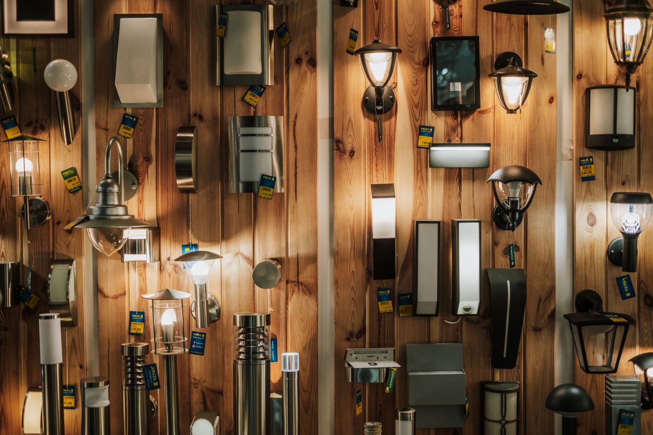 A vibrant display of various wall lamps in a lighting store in Gostyń, Poland.
